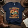 I've Got Friends in Low Places quote with dachshunds, guitar, and campfire on a navy t-shirt