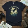 Jackie and Shadow t-shirt design featuring an eagle carrying prey over a mountain range with text