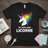 French "Je suis une LICORNE" text with a white unicorn and rainbow mane graphic on a black t-shirt