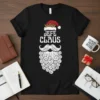 Black t-shirt with "Jefe Claus" text, Santa hat, and beard design in white and red