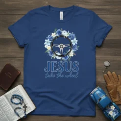 Jesus take the wheel t-shirt design with a steering wheel surrounded by blue flowers and bold text