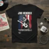 Black t-shirt featuring Jimi Hendrix playing guitar against an American flag backdrop, with "Jimi Hendrix Experience Hendrix LLC" text