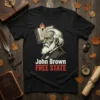 Black t-shirt with John Brown FREE STATE text and portrait, depicting a historical figure and book with flames