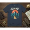 Journey T-Shirt with a stylized mountain landscape, river, and sunset graphic. Features the word "Journey" in bold lettering