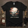 Black t-shirt with "JOURNEY TO THE UNKNOWN" text and a scenic landscape design framed by flowers