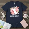 Jumping For Joy! text with a cute white bunny jumping surrounded by pink flowers and leaves on a navy t-shirt