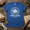 Junior Captain Est. 2024 T-Shirt with a white outline circle graphic of a sailing ship on waves