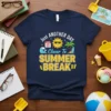 Just Another Day Closer To Summer Break text with sun, calendar, waves, and palm tree graphics on a navy t-shirt