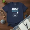 Navy blue t-shirt with white and blue "JUST BREATHE" text and a white lotus flower with a meditating figure inside