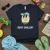 Navy t-shirt with "JUST CHILLIN'" text and a cartoon potato character wearing a blue baseball cap