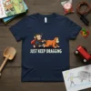 Just Keep Dragging t-shirt with a cartoon monkey in a cape pulling an orangutan by a rope