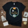 Black t-shirt with "Just Married" text inside a floral wreath, featuring wedding bells and a dove