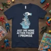 T-shirt with white text "Just One More Action Figure I Promise" above a drawing of a hand holding action figures