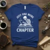 Skeleton reading a book with "Just One More Chapter" text on a navy t-shirt, literary theme
