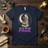 Skeleton owl reading on stacked books with moon and stars, text "Just One More Page Page" on a navy t-shirt