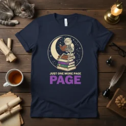 Skeleton owl reading on stacked books with moon and stars, text "Just One More Page Page" on a navy t-shirt