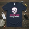 T-shirt with "JUST ONE MORE Piercing I PROMISE" text and a white skull with pink outline and star-shaped eyes