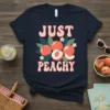 Just Peachy text with retro font and juicy peach graphics on a navy t-shirt