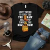 Black t-shirt with white text "JUST TRYING TO FIND THE YEE HAW AND KEEP FINDING THE HELL NAW", featuring a