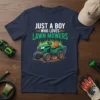 Just A Boy Who Loves Lawn Mowers text with a cartoon riding mower graphic on a navy t-shirt