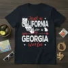 T-shirt with white text "Just a CALIFORNIA girl in a GEORGIA World" overlaying California and Georgia state outlines