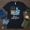 Just a Cold Goose, t-shirt design featuring a goose relaxing by a fireplace, wearing a cozy blanket and hat