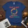 Just a girl who loves Black History text with circular graphic of diverse hands holding books on a navy blue