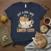 Just A Girl Who Loves Cats text with three cute cats in a coffee cup graphic on a navy t-shirt