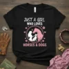Just A Girl Who Loves Horses & Dogs t-shirt design featuring silhouettes of a girl, horse, and dog within a