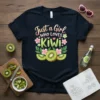Just a Girl WHO LOVES Kiwi text with kiwi slices and flowers graphic on a black t-shirt