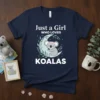 Navy t-shirt with white text "Just a Girl WHO LOVES KOALAS" and a graphic of a sleeping koala on a