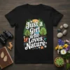 Just a Girl Who Loves Nature text with forest, river, fox, and owl graphic on a black t-shirt