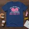 Just a Girl Who Loves New York City text with pink heart and white NYC skyline graphic on navy t-shirt