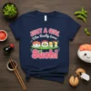 Navy blue t-shirt with "JUST A GIRL Who Really Loves Sushi" text and kawaii sushi characters, including salmon nigiri and