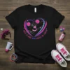 Cheerleader mid-jump inside a heart graphic with text "Just A Girl Who Loves To Cheer" on a black t-shirt