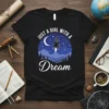 Just a Girl With a Dream rocket launch design on a black t-shirt with moon and stars graphic