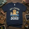 Just a Teacher Who Loves Dogs t-shirt featuring a golden retriever at a desk with books and a globe