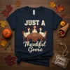 Just A Thankful Goose text design with three geese sitting at a table laden with pies, wearing pilgrim hats