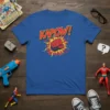 KAPOW! text with a red superhero fist graphic and yellow/red explosion on a blue t-shirt