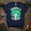 Karma's Coming t-shirt with a white bold font, featuring a swirling green and blue galaxy and a white fist graphic