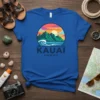 Kauai Hawaii t-shirt with a colorful sunset over mountains, ocean waves, and tropical island scenery