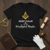 Keep Calm I'm The Worshipful Master text design with Masonic Square and Compasses symbol on a black t-shirt