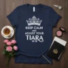 Navy t-shirt with white text "Keep Calm And Adjust Your Tiara" and a decorative crown graphic