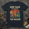Keep Calm And Blame The Healer t-shirt featuring dragon, knight, goblins, and a healer graphic with text in cream color