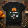Black t-shirt with "Keep Calm And Carve On" text, featuring a happy jack-o'-lantern and carving tools, perfect for Halloween