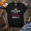 Black t-shirt with "KEEP CALM AND LET Savta HANDLE IT" text and a gold crown graphic