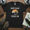 Keep Calm And Pedal On text with mountain biker silhouette graphic on black t-shirt