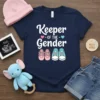 Keeper Of The Gender T-Shirt with pink and blue baby shoes graphic and announcement text