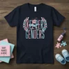 Keeper of the Genders text design with pink and blue lettering, surrounded by floral wreaths, on a navy t-shirt