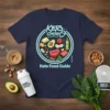 Keto Food Guide T-Shirt design with Keto Chow logo and illustration of keto-friendly foods like avocado, steak, and eggs